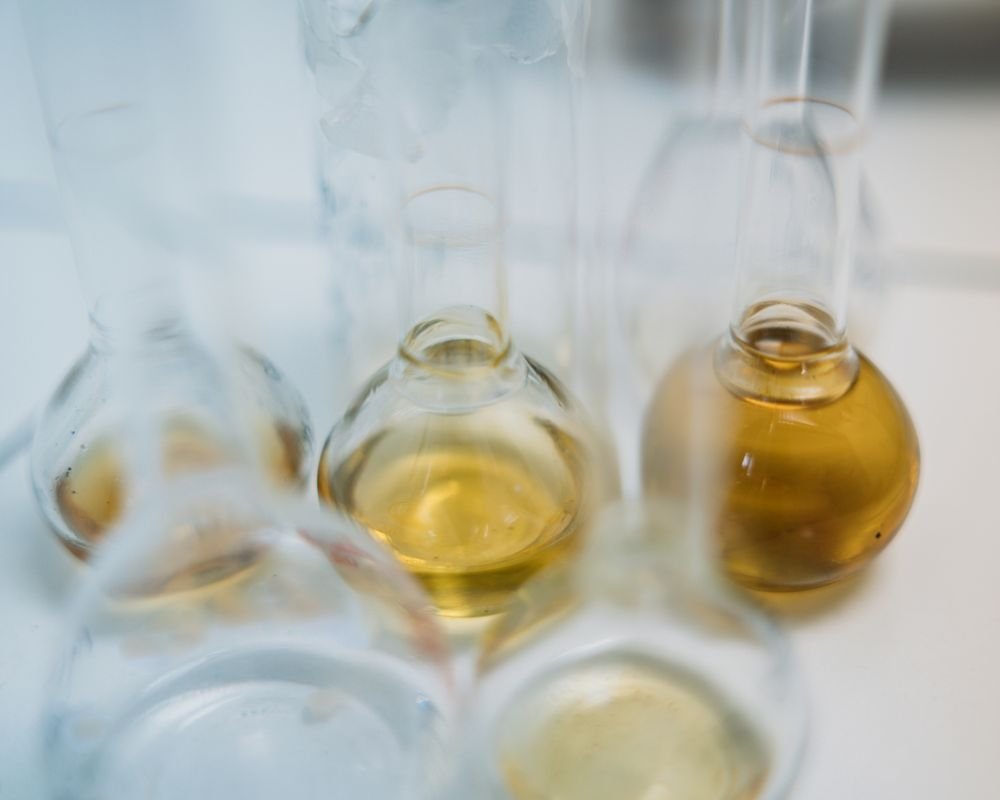 Laboratory glassware with chemical solutions — CNSL and Cardanol bio-based chemicals